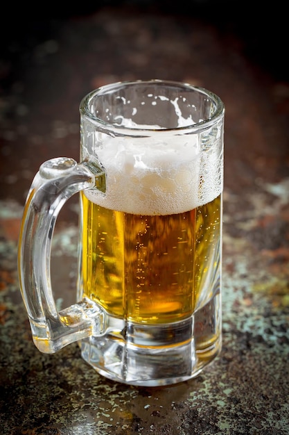 Light beer in a glass on an old background