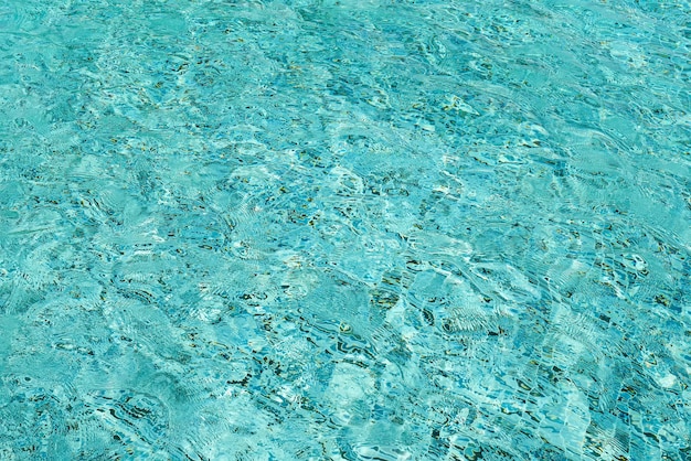 Light blue swimming pool rippled water  background