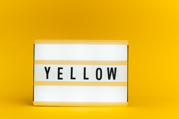 light box with text, YELLOW, on yellow wall