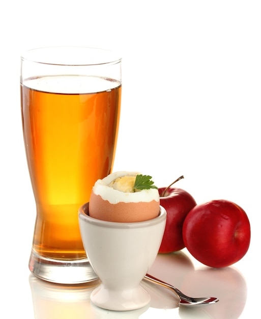 Light breakfast with boiled egg and glass of juice isolated on white