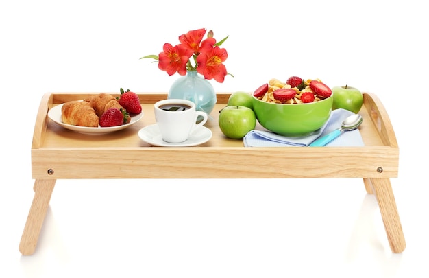 Light breakfast on wooden tray isolated on white