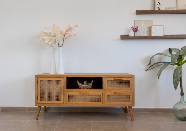 Light brown living room drawer decorated in front of a white wall