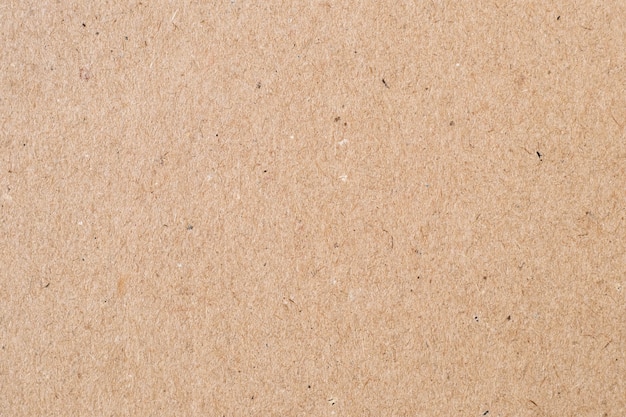 Light brown wrapping paper. Natural sheet surface, packaging background. Texture of cardboard, pasteboard, stiff paper.