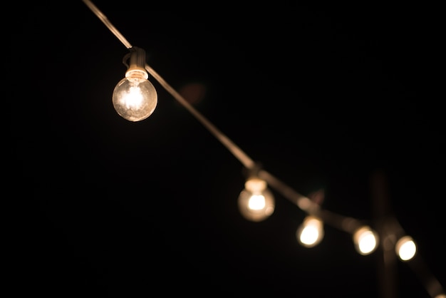 Light bulb on brick wall background switched on