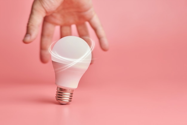 Light bulb and hand as symbol of new ideas