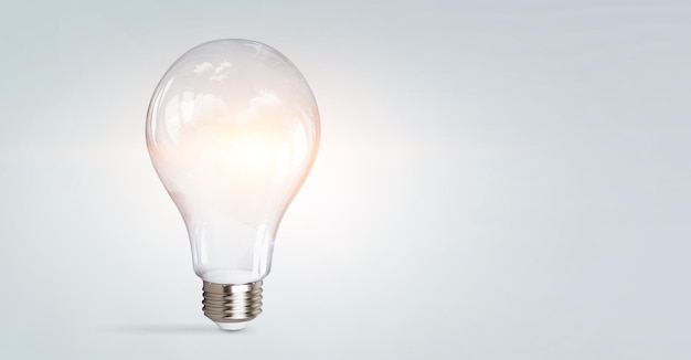 Light bulb on light blue background