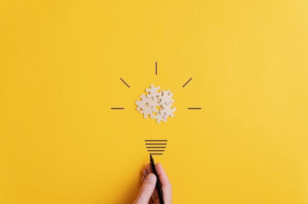 Light bulb over yellow surface in vision and idea conceptual image