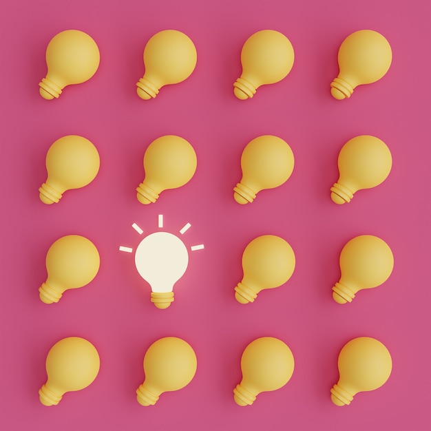 Light bulbs with one of them glowing on pink background