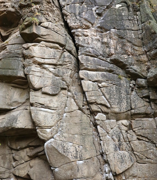 Light coarse natural rock stone background Mining cliff rough front surface Big limestone stack backdrop Heavy grunge damaged granite block texture