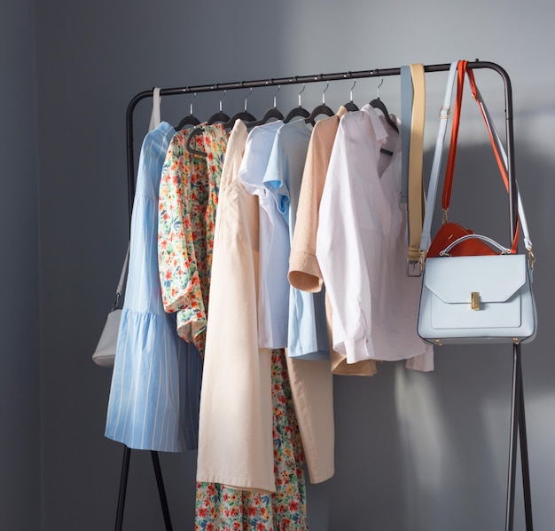 Light colored womens summer clothes and shoes on  hanger