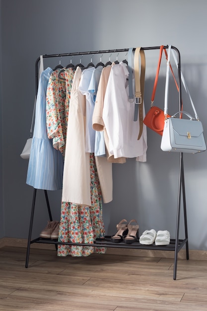 Light colored womens summer clothes and shoes on  hanger