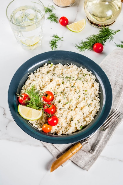 Light dietary food, couscous with tomatoes, lime and fresh herbs 