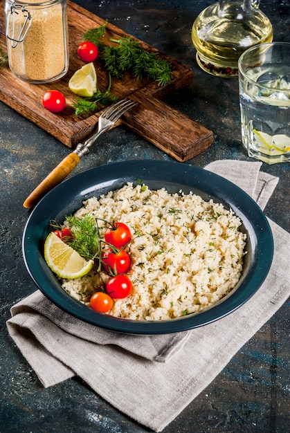 Light dietary food, couscous with tomatoes, lime and fresh herbs 