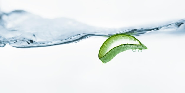 Photo light gray cup with tea and a spoon on a saucer on a white background