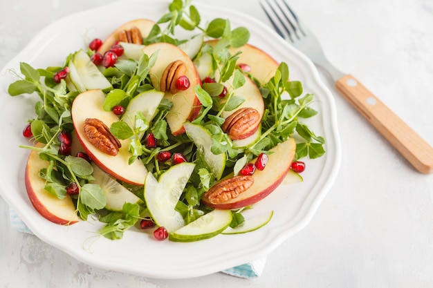 Light green apple pecan pomegranate salad. Vegan Healthy Food Concept. Copy space