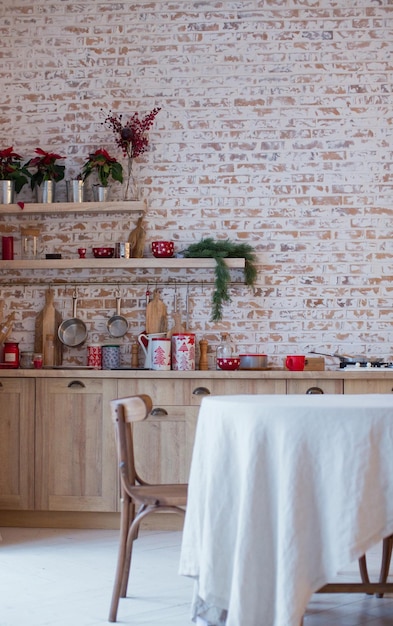 Light kitchen with brick walls and red Christmas decorations and lights