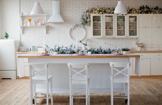 Light kitchen with golden Christmas decorations and lights