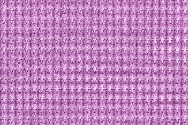 Light purple background from soft fleecy fabric close up. Texture of textiles macro