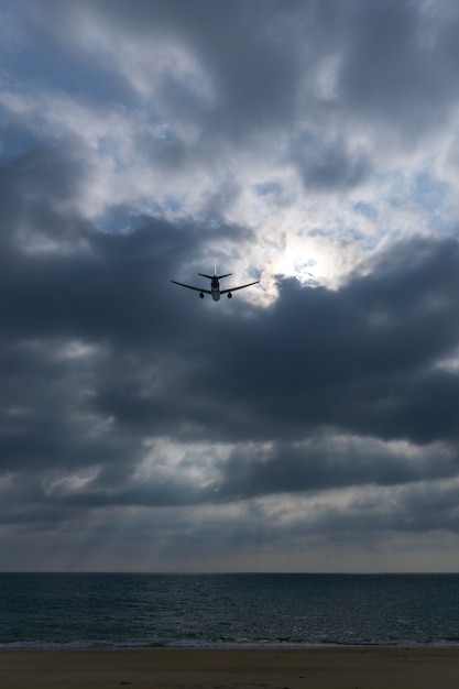 Light ray pierces the cloud with aircraft cross over.