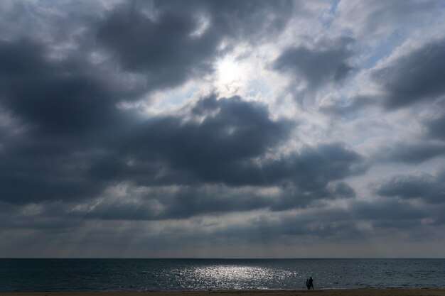 Light ray pierces the cloud with a couple cross over.