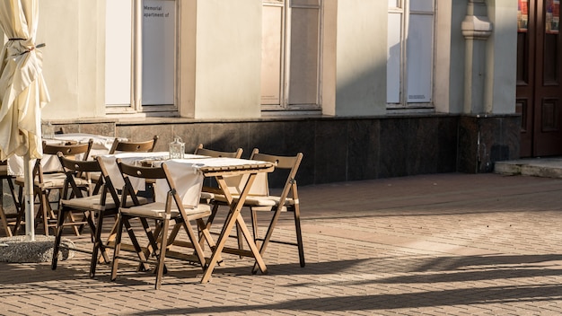 Light and shadow of tables placing outside restaurant waiting for customers in the evening on walking street so called Arbut street , Moscow , Russia