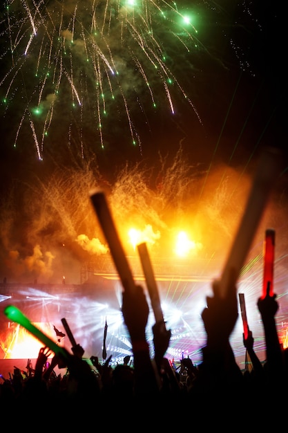 A light show with fireworks at a summer festival.