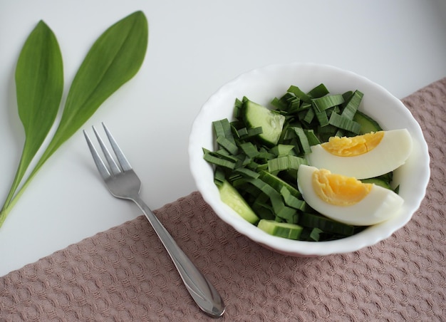 Light summer salad of green onions cucumber and boiled eggs