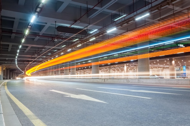 Light trails of vehicles in the tunnel futuristic city road backgroundxA