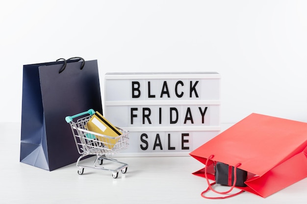 Lightbox with black Friday text shopping cart with credit cart and shopping bags