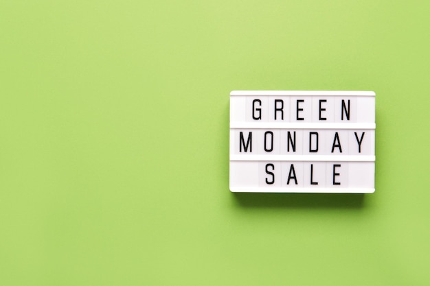 Lightbox with GREEN MONDAY SALE text on green paper background copy space