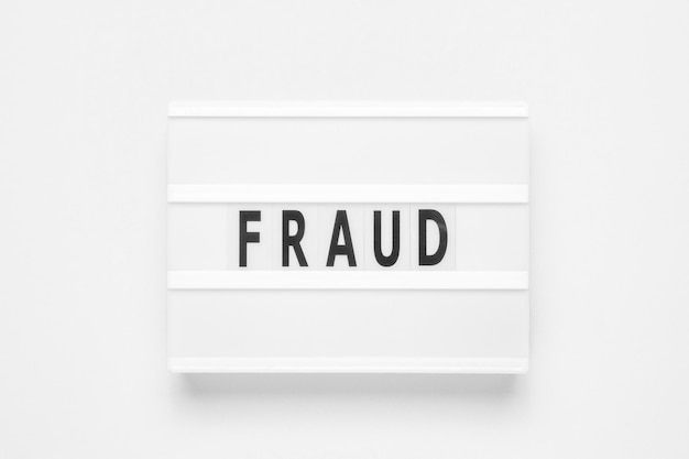 Lightbox with word fraud on white background Business concept