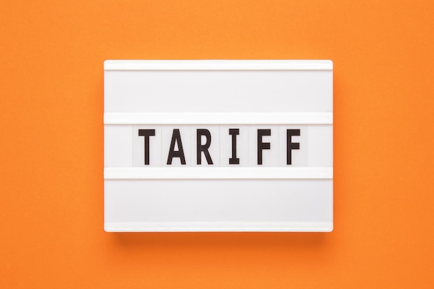 Lightbox with word tariff on orange background Business concept on white background Top view