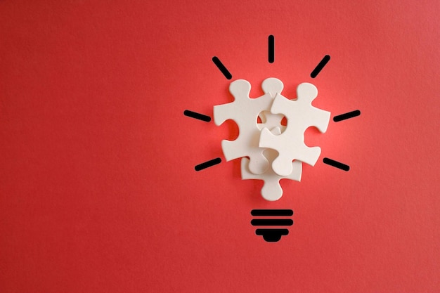 Lightbulb from puzzles on red background with copy space Inspiration creative idea concept