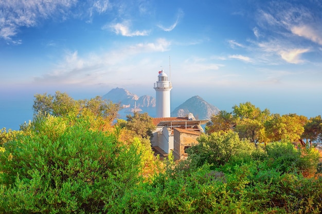 Lighthouse at Cape Gelidonia among green trees