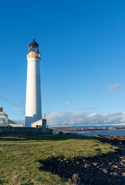 Lighthouse on the coast of the North Sea in Scotland against a dramatic sky