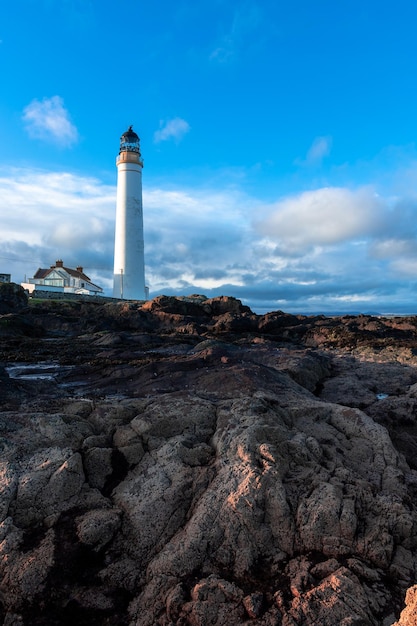 Lighthouse on the coast of the North Sea in Scotland against a dramatic sky