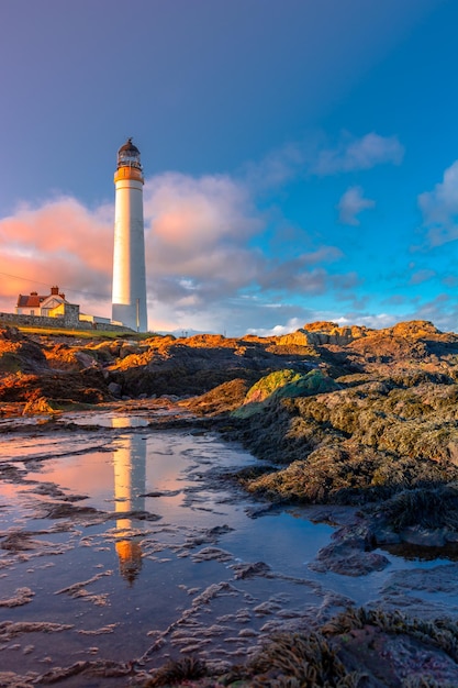 Lighthouse on the coast of the North Sea in Scotland against a dramatic sky