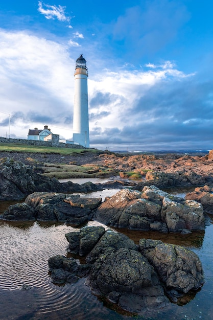 Lighthouse on the coast of the North Sea in Scotland against a dramatic sky