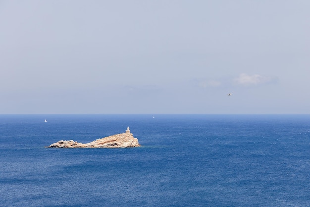 Lighthouse Faro dello Scoglietto di Portoferraio with cylindrical stone tower 8m high, Elba  Italy