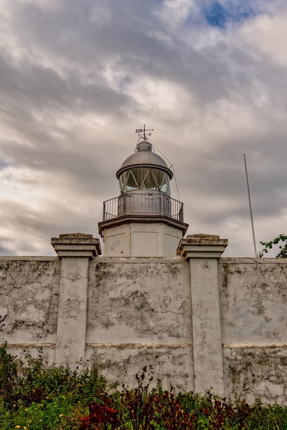 A lighthouse or light signaling tower located on the sea coast or on the mainland