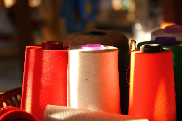 Lighting shadow on yarn spools on bamboo basket