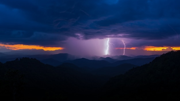 Lightning bolts strike from a sunset storm