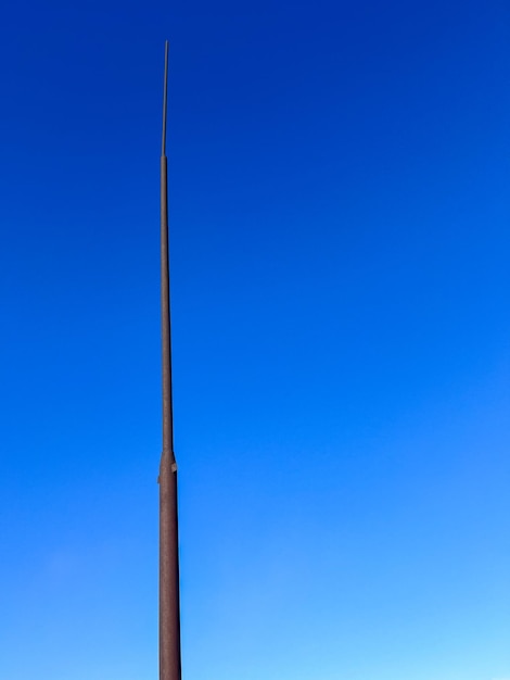 Lightning rod close-up on blue sky background with copyspace