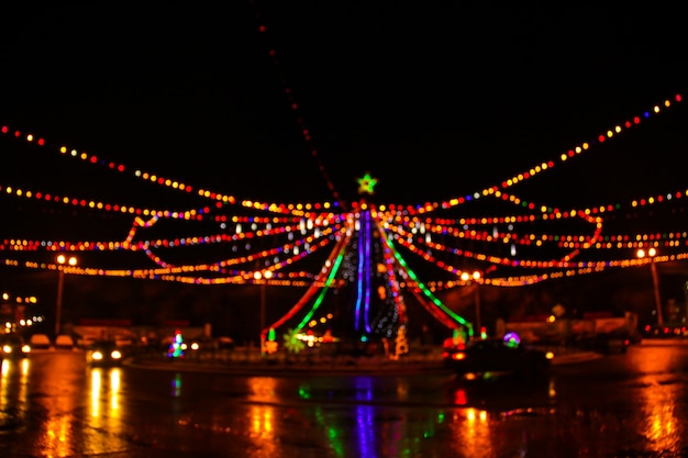 Lights of the christmas tree in the city in blur.