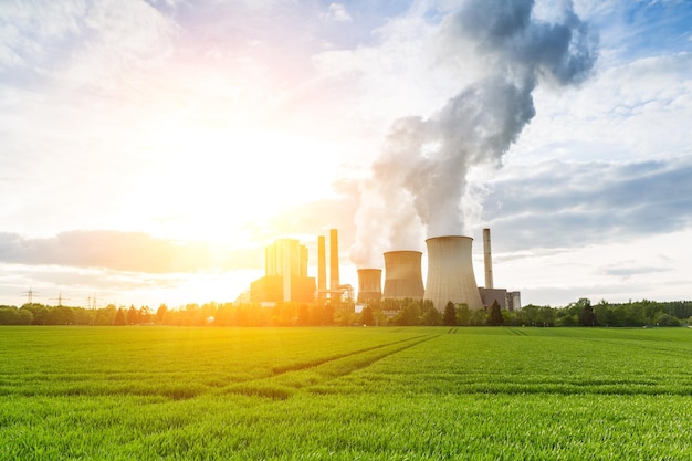 lignite power plant with bright sunlight and cloudy sky