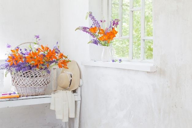 Lilly and lupine flowers in vintage white interior