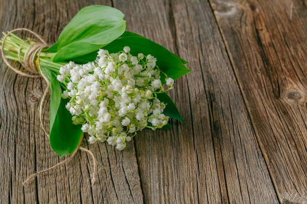 Lily of the valley on wood rustic background