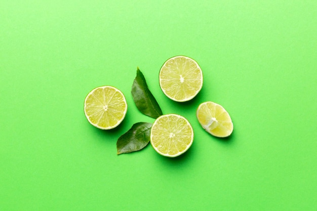 Lime fruits with green leaf and cut in half slice isolated on white background Top view Flat lay with copy space