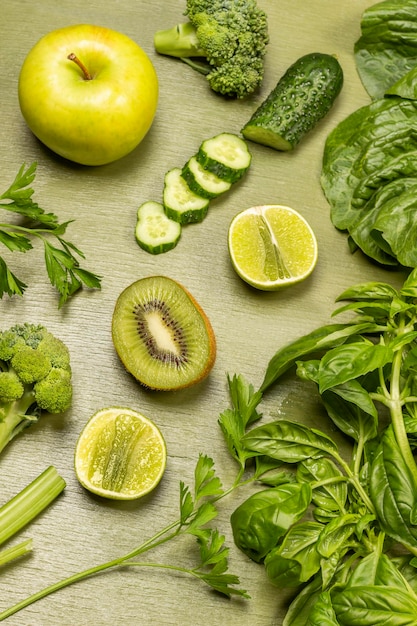 Lime and kiwi halves apple green basil sprigs and chopped cucumber