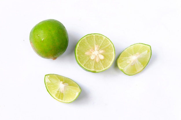 Lime with slices isolated on white background